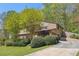 Charming two-story home with mature landscaping, and a driveway leading to the home's entrance at 1735 Little Willeo Rd, Marietta, GA 30068
