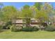Charming two-story home with a lawn and mature landscaping surrounded by trees providing shade and privacy at 1735 Little Willeo Rd, Marietta, GA 30068