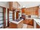 Traditional kitchen featuring wood cabinets, a gas stovetop island, and a large window overlooking the yard at 1735 Little Willeo Rd, Marietta, GA 30068