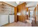 Laundry room with a washing machine, dryer, storage shelves, and view into the kitchen at 1735 Little Willeo Rd, Marietta, GA 30068