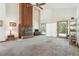 Spacious living room with a stone fireplace, high ceilings, ceiling fan, and sliding glass doors to the outside at 1735 Little Willeo Rd, Marietta, GA 30068