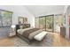 Bright bedroom with stylish furnishings and access to a private balcony overlooking a wooded area at 1735 Little Willeo Rd, Marietta, GA 30068