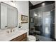 Modern bathroom features a glass shower, black subway tile, and sleek fixtures for a luxurious spa-like experience at 2193 Virginia Ne Pl, Atlanta, GA 30305