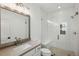 Modern bathroom boasts a large vanity with a bright white glass shower and contemporary fixtures at 2193 Virginia Ne Pl, Atlanta, GA 30305