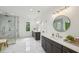 Bright bathroom showcasing double vanity sinks, walk-in glass shower, and modern fixtures at 2193 Virginia Ne Pl, Atlanta, GA 30305