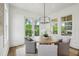 Cozy dining area with a round table, comfortable chairs, and natural light from the windows at 2193 Virginia Ne Pl, Atlanta, GA 30305