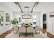 Elegant dining room with hardwood floors, wood beams, designer lighting, and large windows at 2193 Virginia Ne Pl, Atlanta, GA 30305