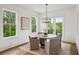 Elegant dining room featuring large windows and a modern chandelier and wood table at 2193 Virginia Ne Pl, Atlanta, GA 30305