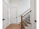 Hallway featuring hardwood floors and a staircase with iron railings and a wood banister at 2193 Virginia Ne Pl, Atlanta, GA 30305