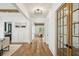 Bright hallway with hardwood floors, decorative lighting, wainscoting, and glass French doors at 2193 Virginia Ne Pl, Atlanta, GA 30305
