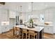 Large kitchen with white cabinetry, a huge island with seating, and hardwood floors at 2193 Virginia Ne Pl, Atlanta, GA 30305