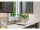 Modern kitchen design with sleek countertops and backsplash, and a wine fridge at 2193 Virginia Ne Pl, Atlanta, GA 30305