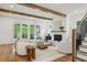 Inviting living room featuring hardwood floors, a fireplace, wood beams, and French doors to the outdoors at 2193 Virginia Ne Pl, Atlanta, GA 30305