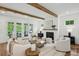 Inviting living room featuring hardwood floors, a fireplace, wood beams, and French doors to the outdoors at 2193 Virginia Ne Pl, Atlanta, GA 30305