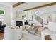 Bright living room with hardwood floors, fireplace, staircase, modern lighting and comfortable seating at 2193 Virginia Ne Pl, Atlanta, GA 30305