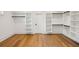 Spacious walk-in closet with custom built-in shelving and hardwood floors, ideal for organized storage at 2193 Virginia Ne Pl, Atlanta, GA 30305