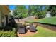 A backyard with manicured lawn, a charming shed, and an outdoor seating area with brick patio at 2227 Austin Lake Se Dr, Smyrna, GA 30082