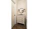 Elegant powder room features stylish wallpaper, vanity with marble countertop, and modern fixtures at 2227 Austin Lake Se Dr, Smyrna, GA 30082