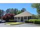 Community clubhouse surrounded by lush trees, pristine landscaping, and ample parking at 2227 Austin Lake Se Dr, Smyrna, GA 30082
