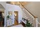 Grand foyer with hardwood floors, staircase, bench, and a view into the kitchen at 2227 Austin Lake Se Dr, Smyrna, GA 30082