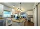 Bright kitchen featuring white cabinets, granite counters, island with cooktop, and modern lighting at 2227 Austin Lake Se Dr, Smyrna, GA 30082