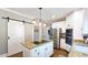 Well-appointed kitchen island featuring granite countertops, stainless steel appliances, and unique sliding barn door at 2227 Austin Lake Se Dr, Smyrna, GA 30082