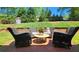Brick patio featuring stylish outdoor furniture, green lawn, and a cute white dog enjoying the view at 2227 Austin Lake Se Dr, Smyrna, GA 30082