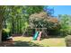 Community playground featuring swings, slide and climbing structure, surrounded by mature trees and landscaping at 2227 Austin Lake Se Dr, Smyrna, GA 30082