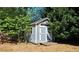 Outdoor shed for storage, nestled among mature trees, with a ramp for easy access at 2227 Austin Lake Se Dr, Smyrna, GA 30082