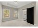 Bright main bedroom with a barn door to the main bathroom, and two bright windows at 2333 Mason Dr # D26, Atlanta, GA 30316