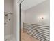 Hallway with modern railing, wood floors, and utility connections visible on the wall at 2333 Mason Dr # D26, Atlanta, GA 30316