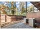 A cozy patio area with a wood fence, gravel and two A/C units creates a private outdoor retreat at 2333 Mason Dr # D26, Atlanta, GA 30316