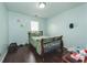 Bedroom featuring a metal bed frame, hardwood floors, and neutral colored walls at 275 Fern Crest Dr, Lawrenceville, GA 30046