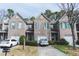 Charming townhouse with stone and brick facade, attached garages, and well-maintained landscaping at 275 Fern Crest Dr, Lawrenceville, GA 30046