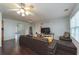 Open-concept living room with hardwood floors, a large sofa, and natural light at 275 Fern Crest Dr, Lawrenceville, GA 30046