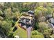 Aerial shot of home revealing the large lot, mature trees, circular driveway, and outdoor building at 3920 Maybreeze Rd, Marietta, GA 30066