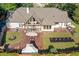 Aerial view of a home with extensive patios, outdoor fireplace, landscaped yard, and a lush green lawn at 3920 Maybreeze Rd, Marietta, GA 30066