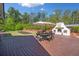 Outdoor patio area featuring a table, chairs, large umbrella, and outdoor fireplace at 3920 Maybreeze Rd, Marietta, GA 30066