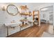 Bright bathroom featuring double sinks, wood floors, a white shiplap wall, and modern shelving at 3920 Maybreeze Rd, Marietta, GA 30066