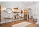 Bright bathroom featuring double sinks, wood floors, a white shiplap wall, and modern shelving at 3920 Maybreeze Rd, Marietta, GA 30066