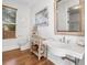 Charming bathroom featuring a rustic vanity, framed mirror, stylish decor, and a window for natural light at 3920 Maybreeze Rd, Marietta, GA 30066