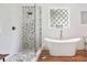 Bright bathroom featuring a modern tub, glass shower, and unique tilework at 3920 Maybreeze Rd, Marietta, GA 30066