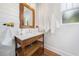 Charming bathroom with a rustic wood vanity, marble countertop, shiplap walls, and a modern mirror at 3920 Maybreeze Rd, Marietta, GA 30066