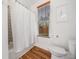 Bright bathroom features stylish geometric tile, a white shower curtain, and a window for natural light at 3920 Maybreeze Rd, Marietta, GA 30066
