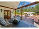 Charming covered patio with outdoor fireplace, dining area, and comfortable lounge seating at 3920 Maybreeze Rd, Marietta, GA 30066