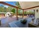 Spacious covered patio featuring brick and wood columns with a fireplace and lounge area at 3920 Maybreeze Rd, Marietta, GA 30066