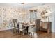 Formal dining room featuring stylish wallpaper, wood floors, and elegant chandelier at 3920 Maybreeze Rd, Marietta, GA 30066