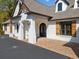 Elegant home entrance with brick accents, arched doorway and wood shutters at 3920 Maybreeze Rd, Marietta, GA 30066