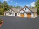 Home exterior featuring beautiful wood trim, gabled roof and a spacious driveway at 3920 Maybreeze Rd, Marietta, GA 30066