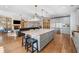 Kitchen with center island and stainless steel appliances flows into living area at 3920 Maybreeze Rd, Marietta, GA 30066